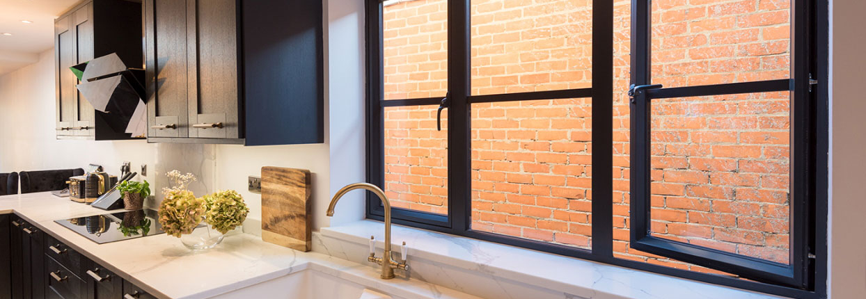 Turners-Hill-double-glazing-companies Black-framed uPVC windows above a kitchen sink, a finish for Crawley homes