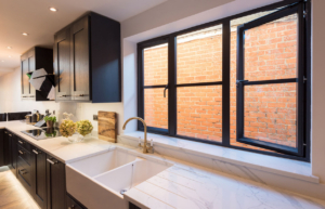 Black-framed uPVC windows above a kitchen sink, a finish for Crawley homes