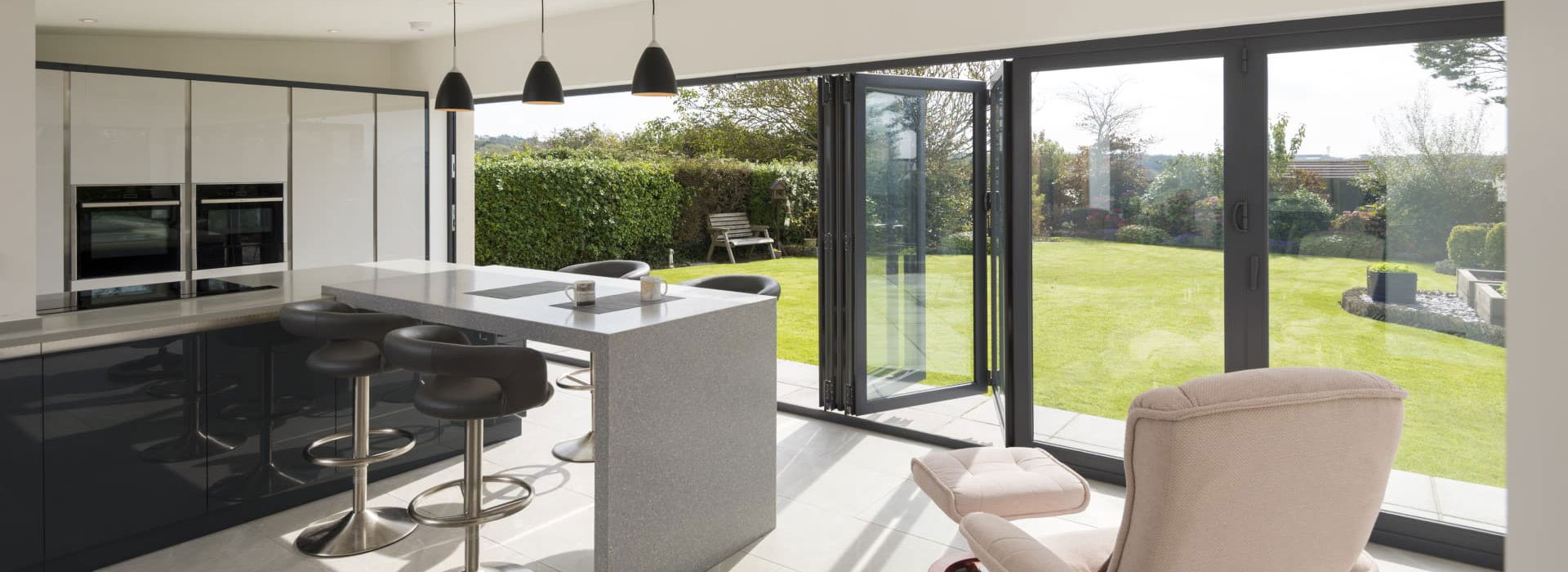Bifold doors areas covered: aluminium bifold doors folded open to a patio