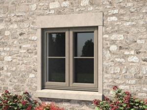 Grey-framed uPVC window set in a stone wall